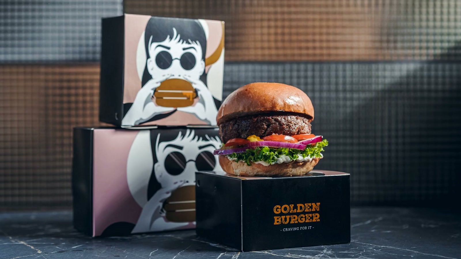 Golden Burger stacked on its black-and-gold packaging box